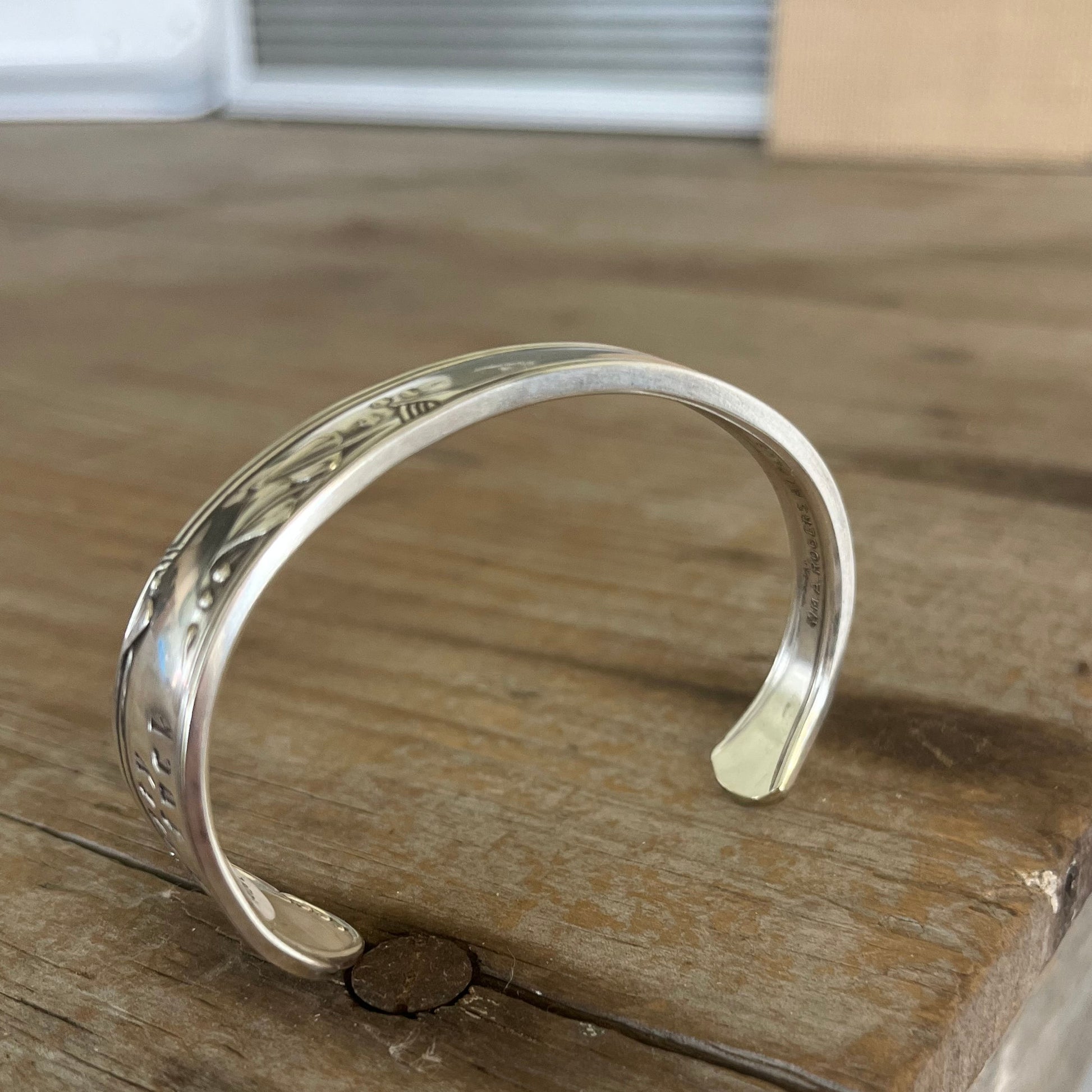 Curved view of FUCKITY FUCK FUCK hand-stamped spoon cuff bracelet with modern font - 1936 W.A. Rogers Meadowbrook - upcycled vintage silverware - Laughing Frog Studio