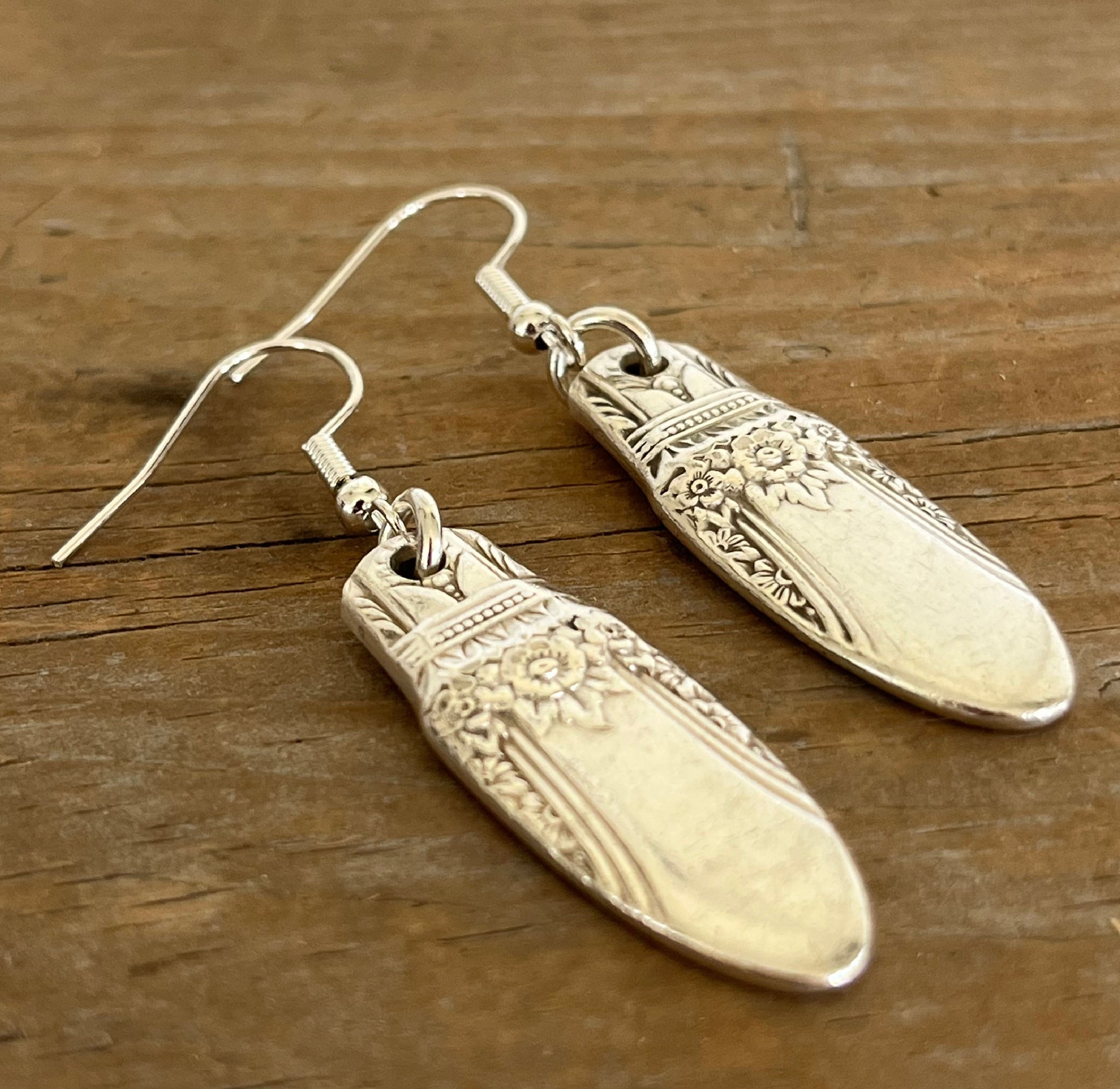 Close-up of FIRST LOVE pattern spoon handle drop earrings - spoon earrings - handcrafted from upcycled vintage silverware - Laughing Frog Studio