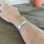 FUCKITY FUCK FUCK hand-stamped spoon cuff bracelet shown on model wrist - 1936 William A. Rogers - upcycled vintage silverware - Laughing Frog Studio