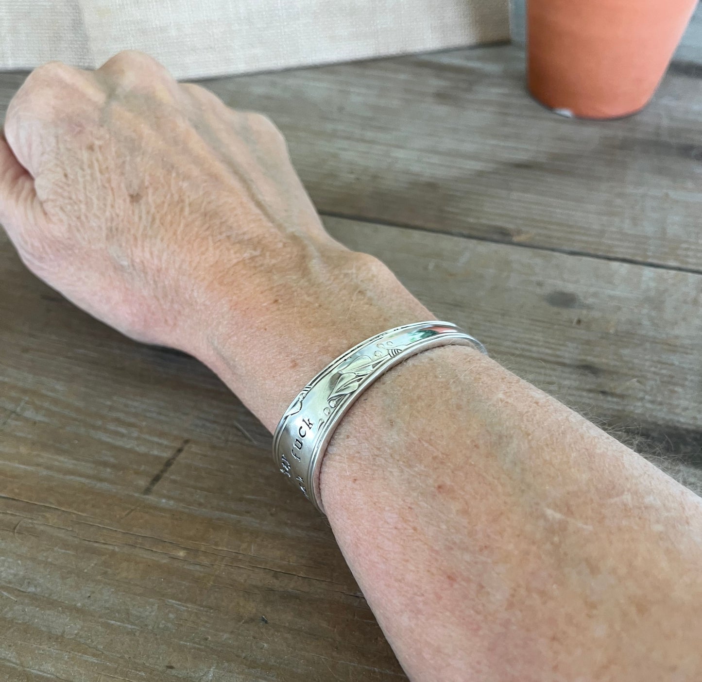 FUCKITY FUCK FUCK hand-stamped spoon cuff bracelet shown on model wrist - 1936 William A. Rogers - upcycled vintage silverware - Laughing Frog Studio