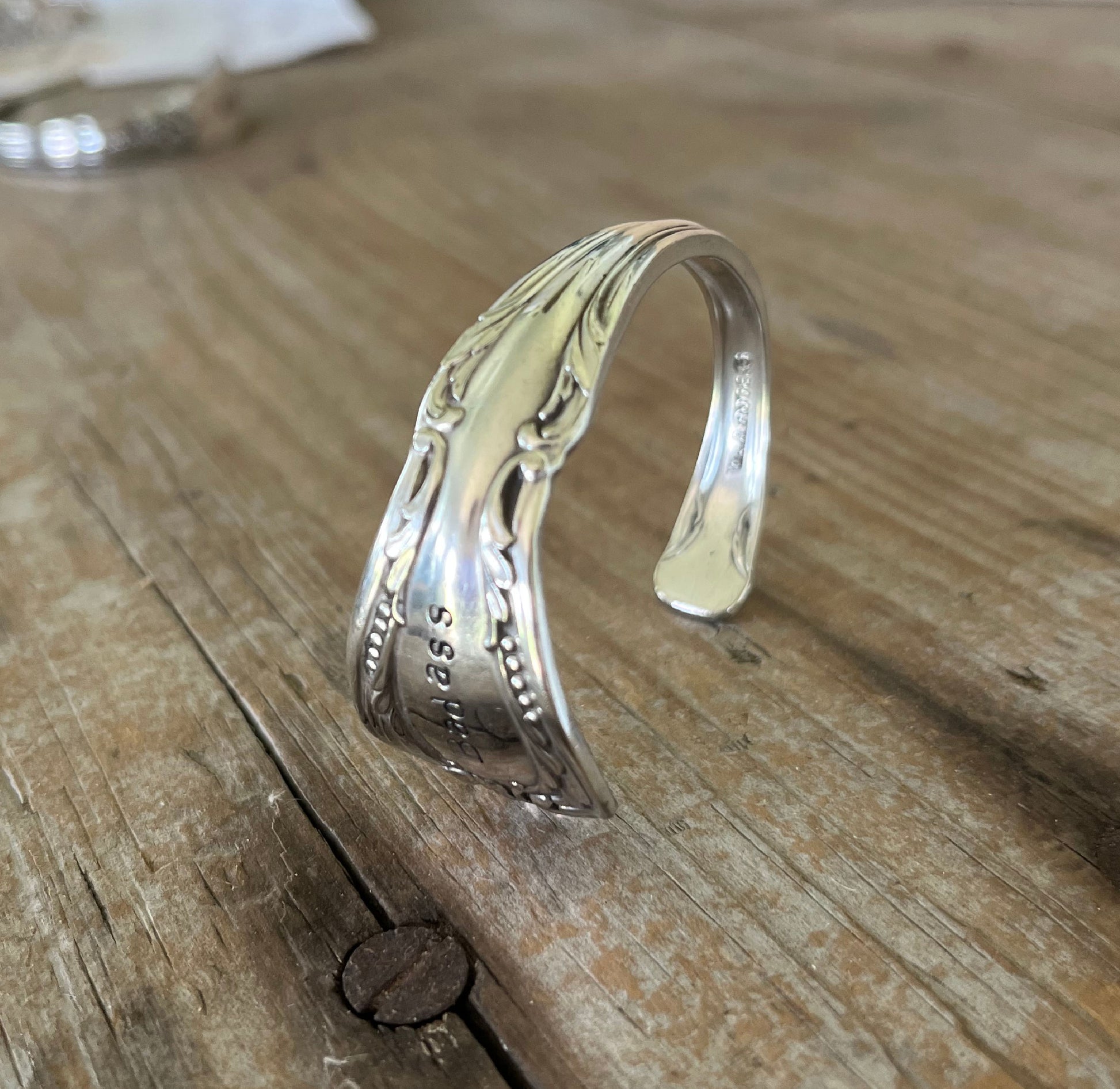 Top view of Chalice BADASS hand-stamped spoon cuff bracelet - upcycled vintage silverware - Laughing Frog Studio