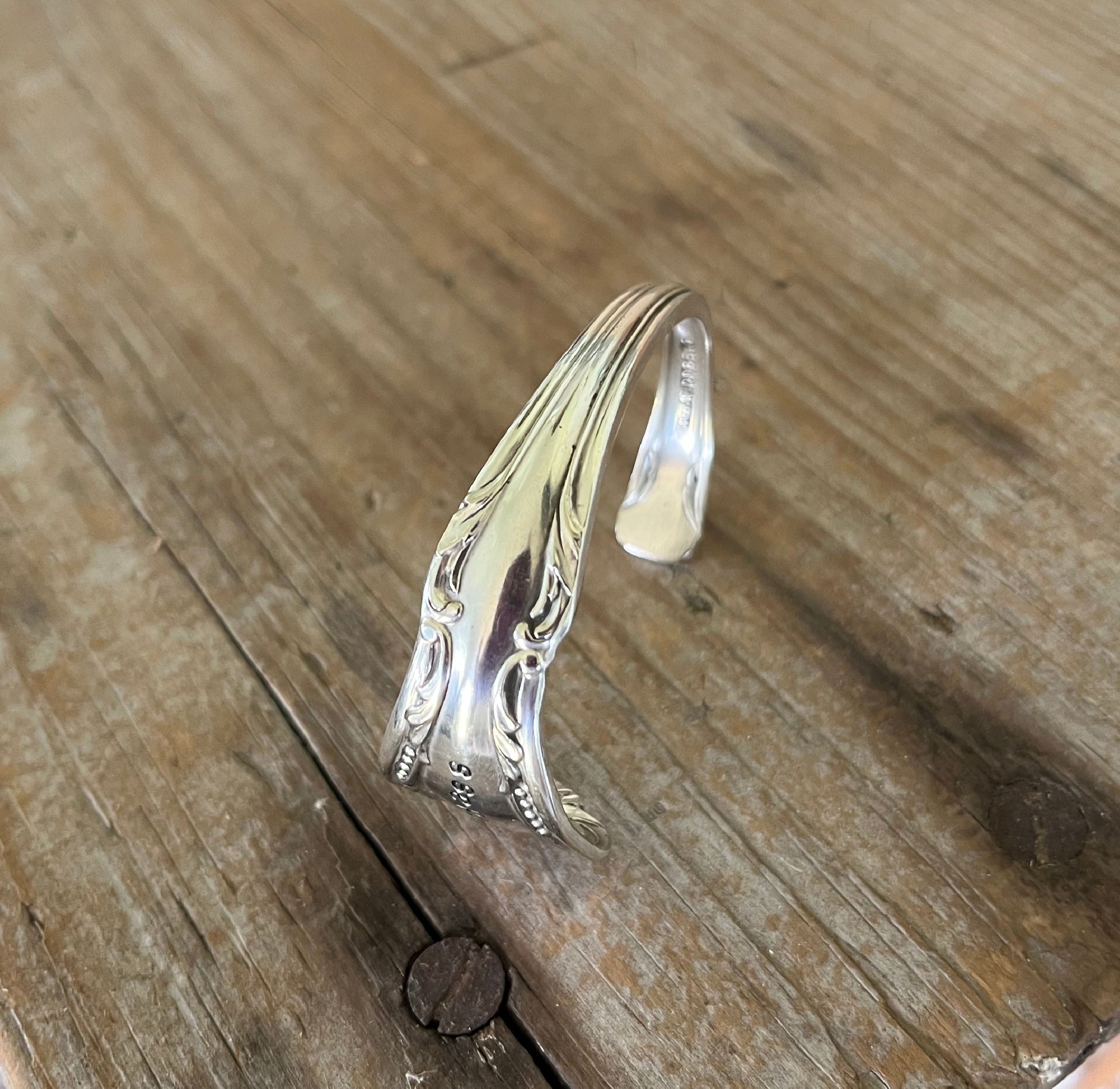 Detail view of detail on Chalice BADASS hand-stamped spoon cuff bracelet - upcycled vintage silverware - Laughing Frog Studio