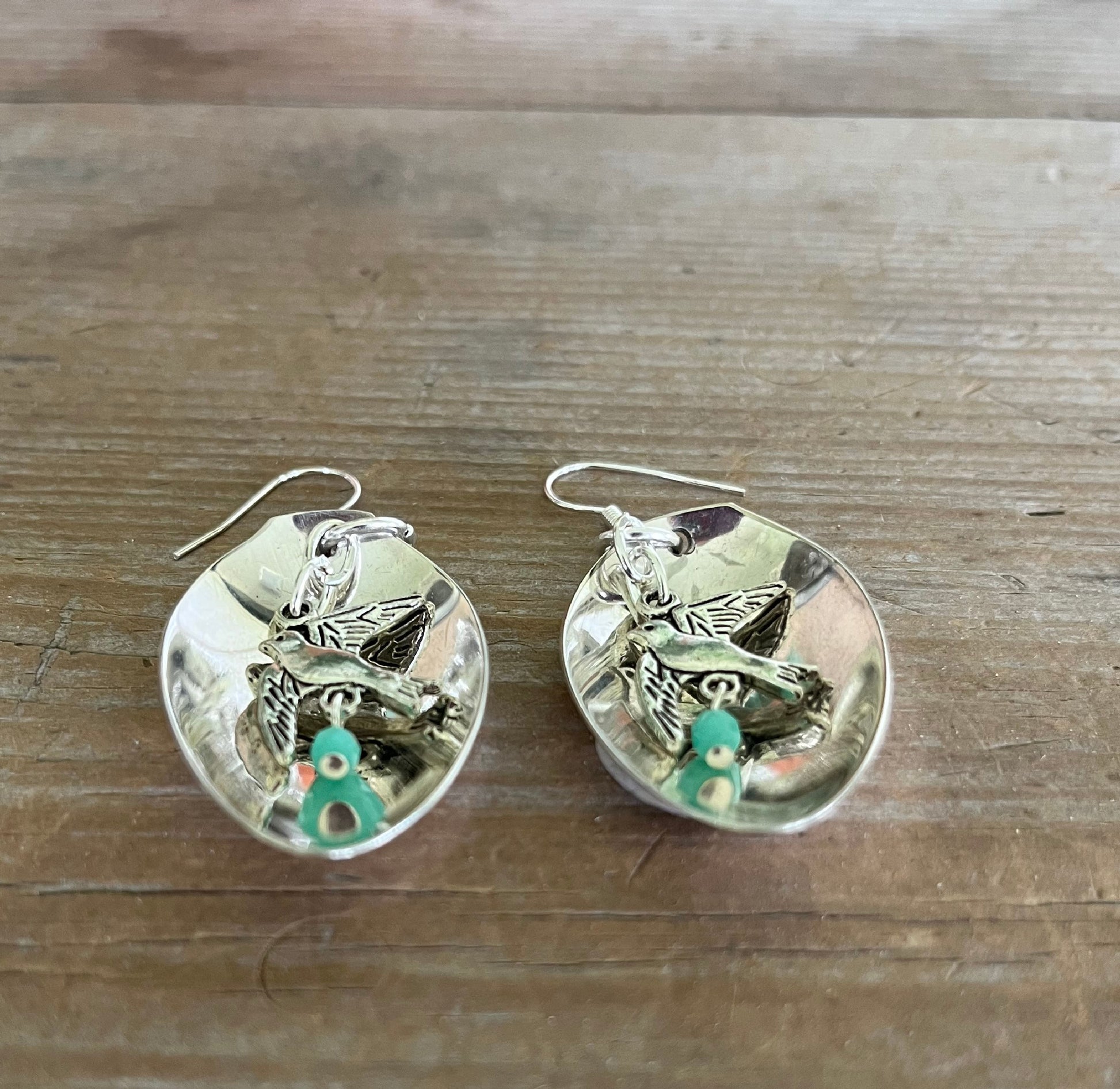 Upcycled demitasse spoon earrings with peace bird and dark jadeite accents, side view - Spoon Earrings - handcrafted from upcycled vintage silverware - Laughing Frog Studio