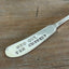 Close-up of stamping on 1847 Rogers Bros Heritage spreader - hand-stamped "Who Cut the Cheese?" - upcycled vintage silverware - Laughing Frog Studio