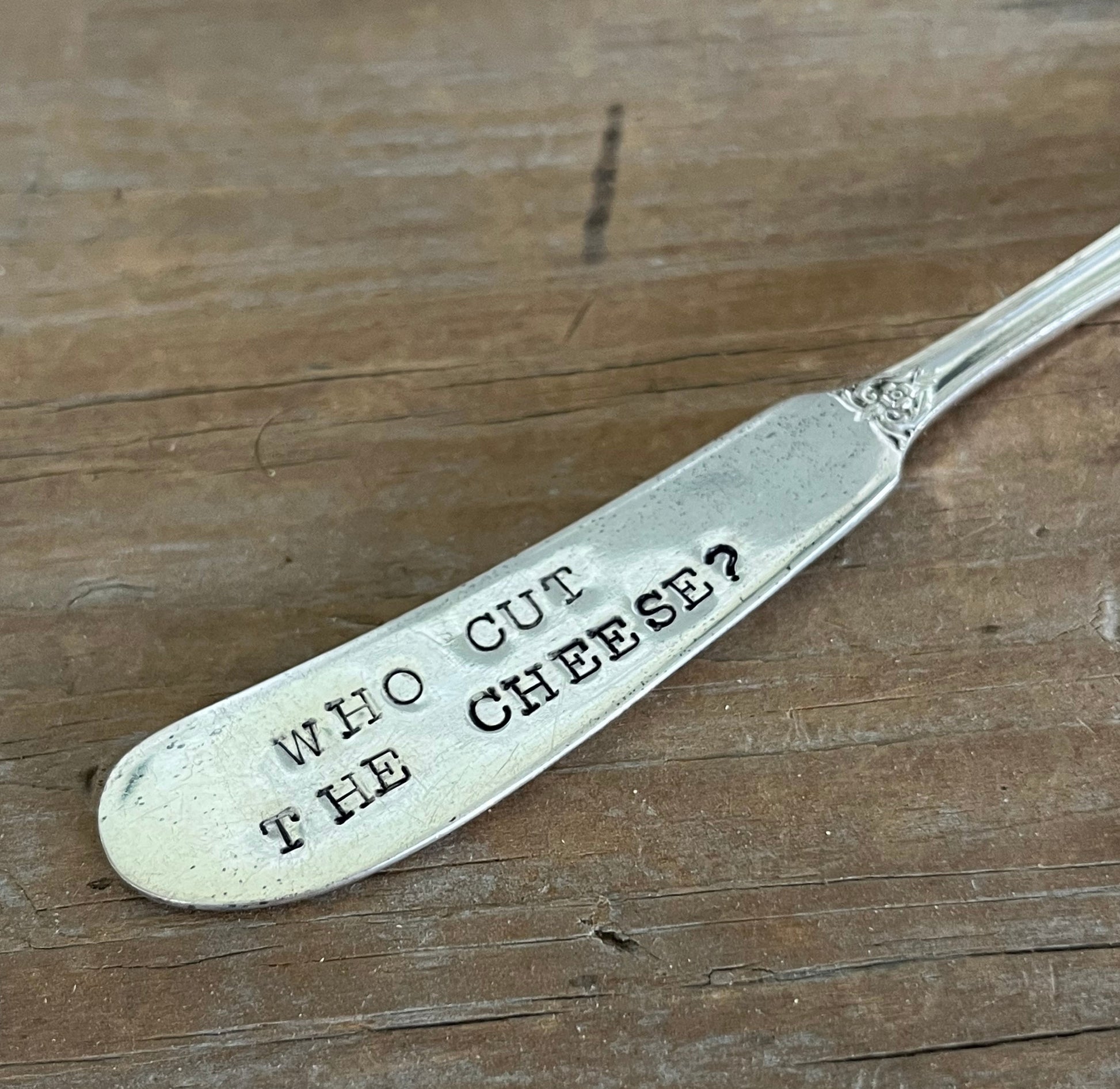 Close-up of stamping on 1847 Rogers Bros Heritage spreader - hand-stamped "Who Cut the Cheese?" - upcycled vintage silverware - Laughing Frog Studio