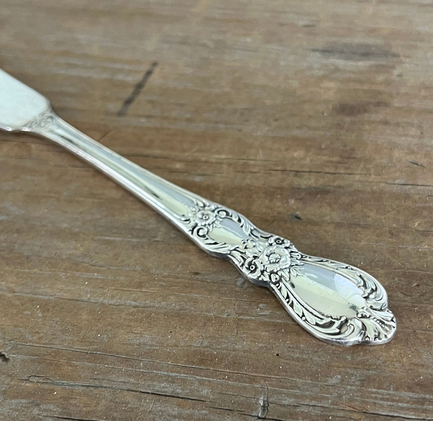 Close-up of handle design on 1847 Rogers Bros Heritage spreader - hand-stamped "Who Cut the Cheese?" - upcycled vintage silverware - Laughing Frog Studio