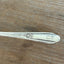 William Rogers Memory/Hiawatha spreader - hand-stamped "Who Cut the Cheese?" - close up of handle - upcycled vintage silverware - Laughing Frog Studio