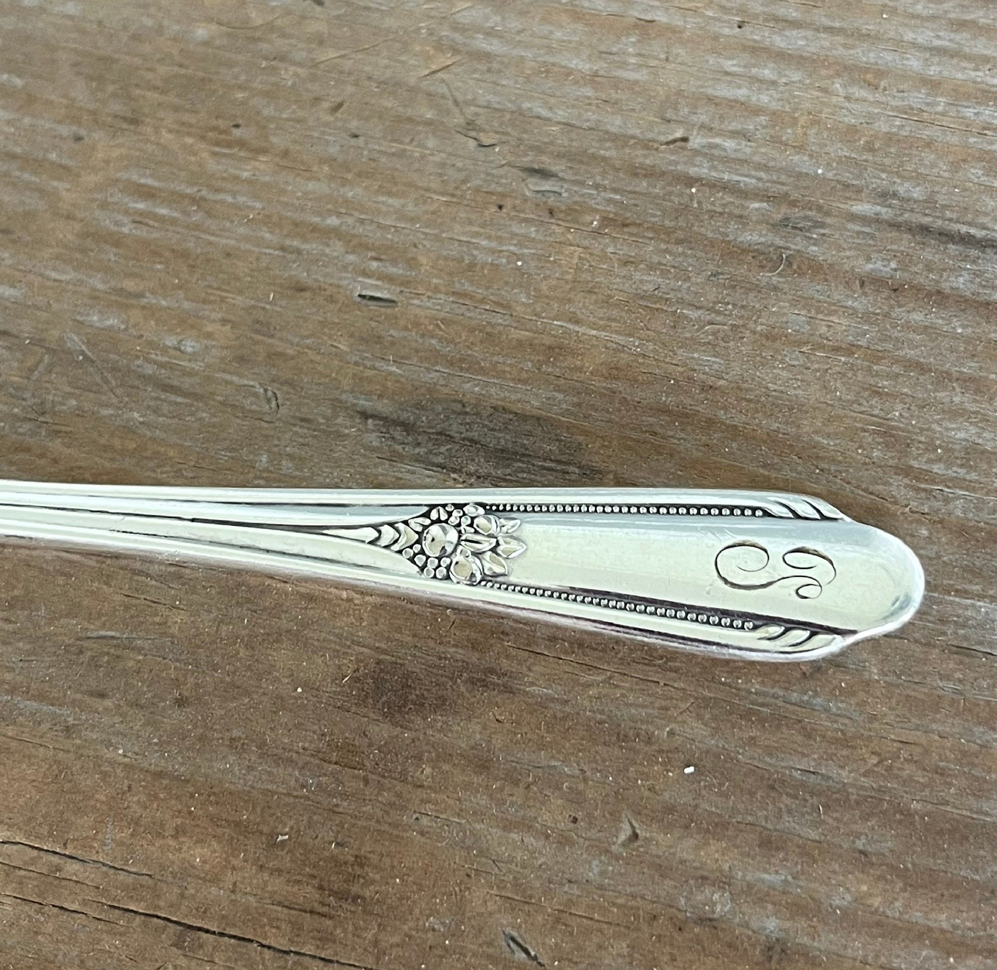 William Rogers Memory/Hiawatha spreader - hand-stamped "Who Cut the Cheese?" - close up of handle - upcycled vintage silverware - Laughing Frog Studio