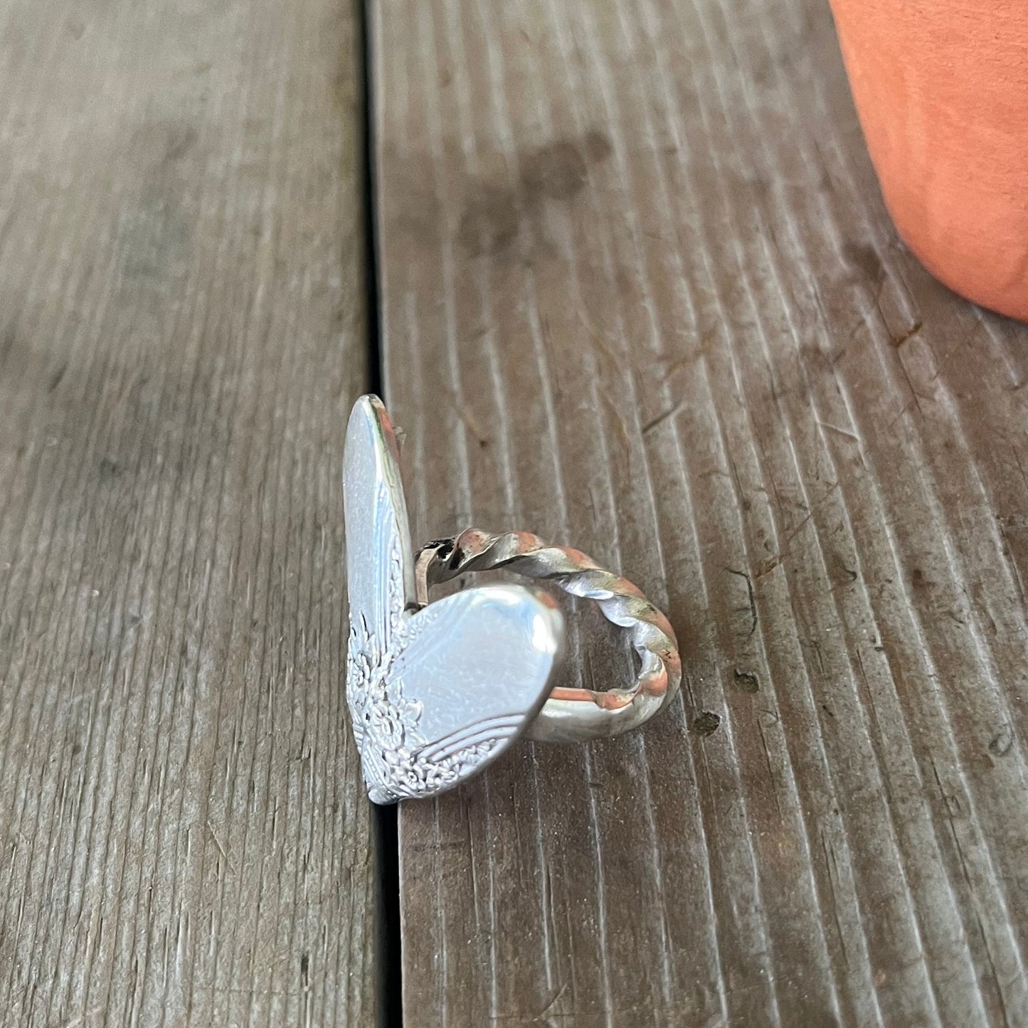 Top view of FIRST LOVE pattern sculpted heart statement ring and unique twisted shank - handcrafted from upcycled vintage silverware - Laughing Frog Studio