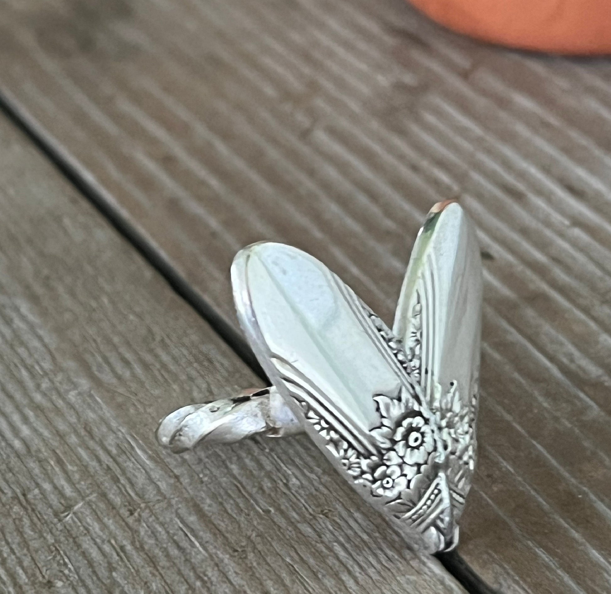 Close-up of FIRST LOVE pattern sculpted heart statement ring highlighting twisted shank - handcrafted from upcycled vintage silverware - Laughing Frog Studio