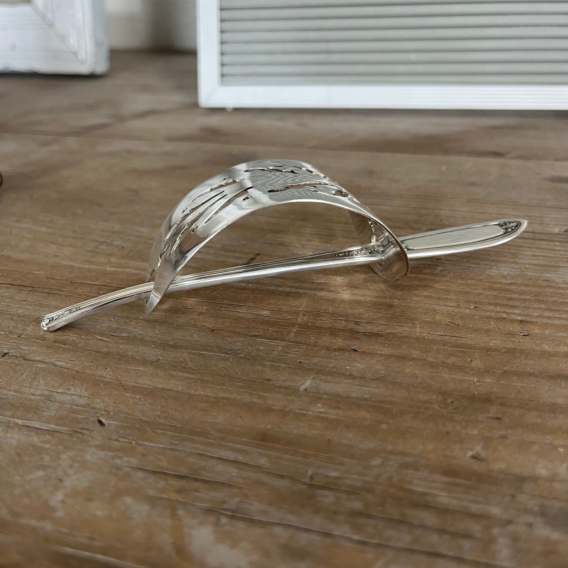 Side view of cake server hair barrette with filigree cutout and Enchantment flower stick pin - handcrafted upcycled vintage silverware hair accessory - Laughing Frog Studio