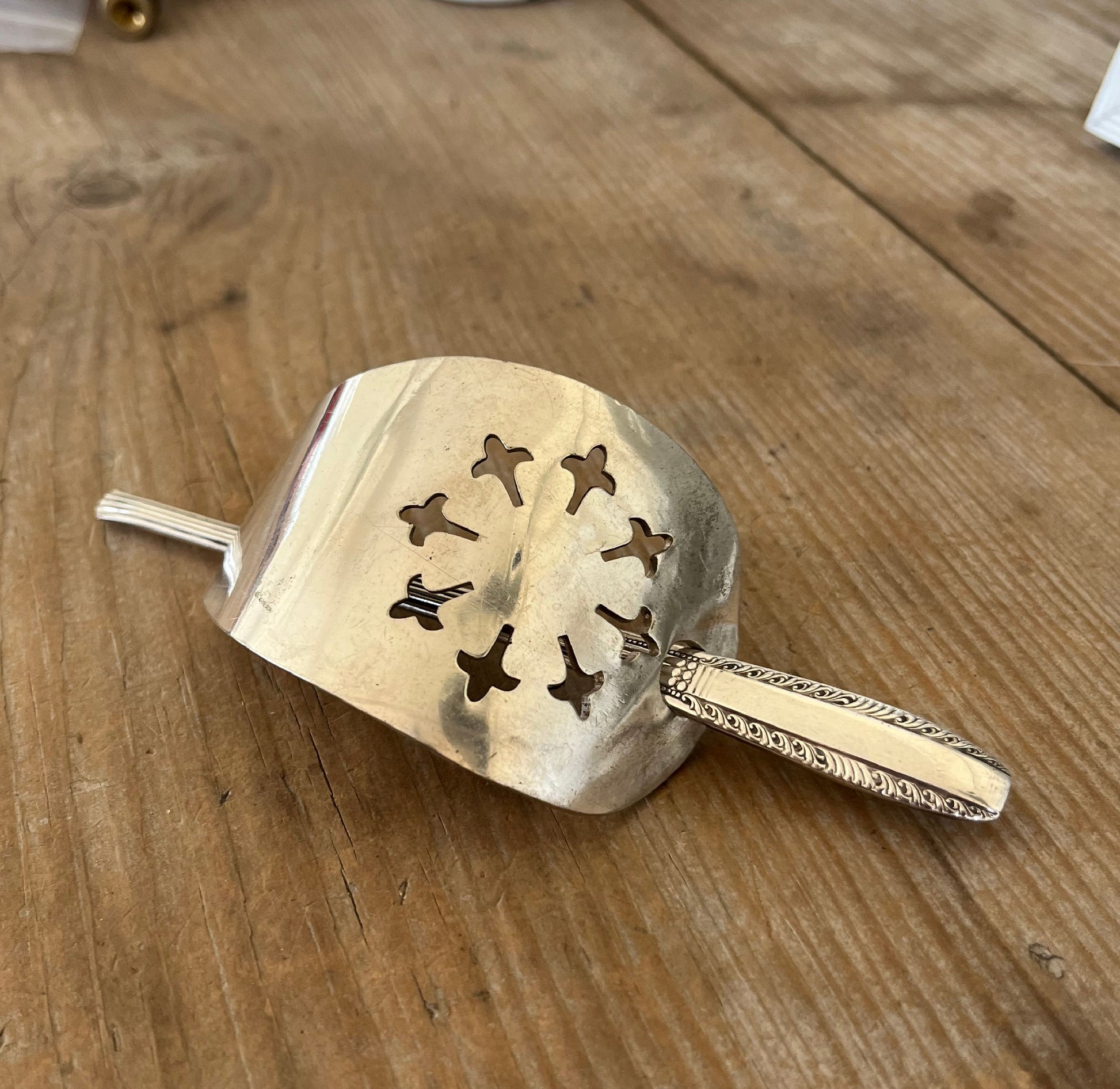 Handcrafted hair barrette from upcycled vintage cake server showing decorative details