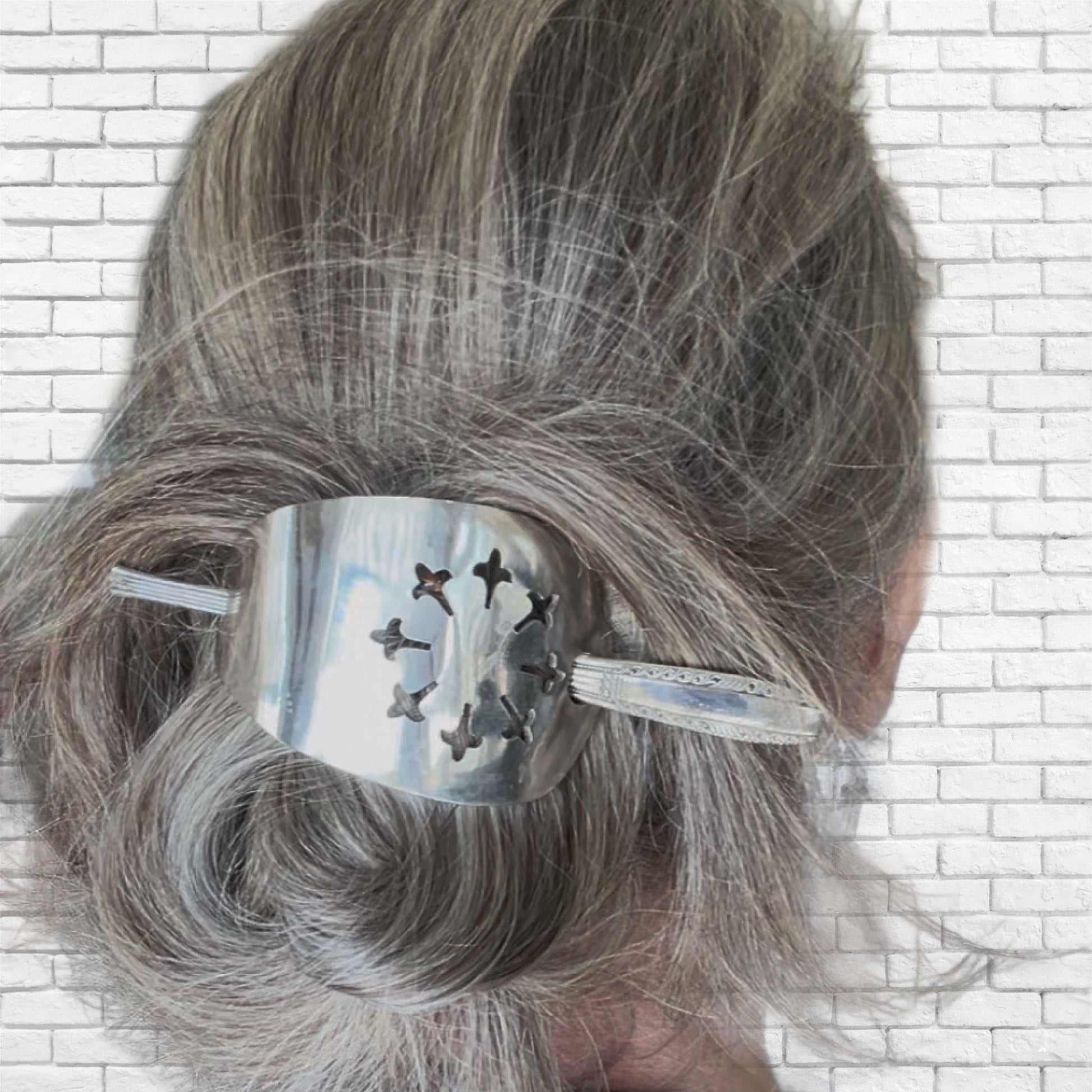 Handmade upcycled silverware cake server hair barrette worn in hair showing functionality and beauty
