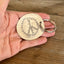 Peace sign hand-stamped spoon keychain shown in hand for scale - handcrafted from upcycled vintage silverware - Laughing Frog Studio