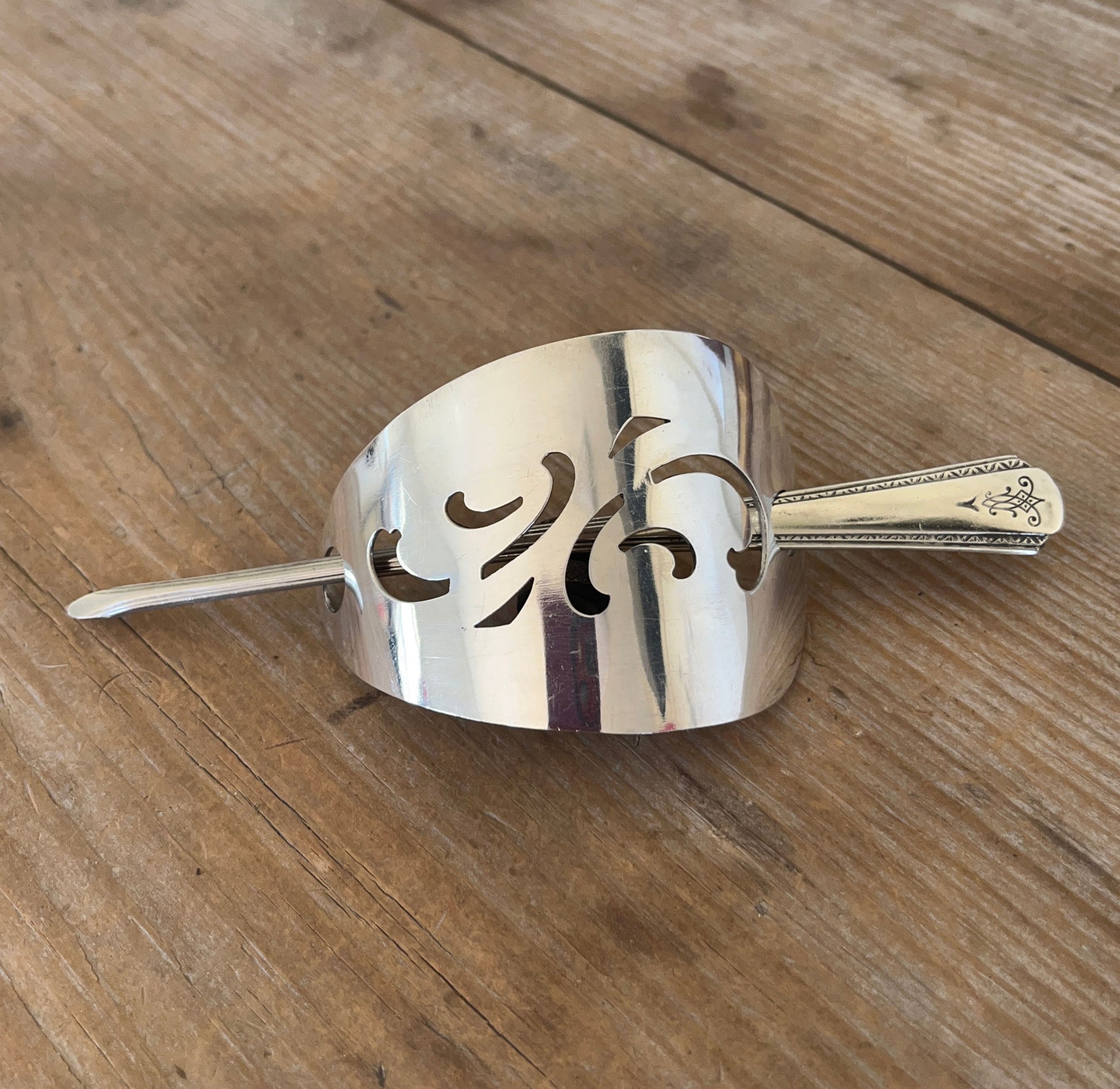 Close up of Senate Silverplate Jean cake server hair barrette with stick - handcrafted from upcycled vintage silverware - Laughing Frog Studio