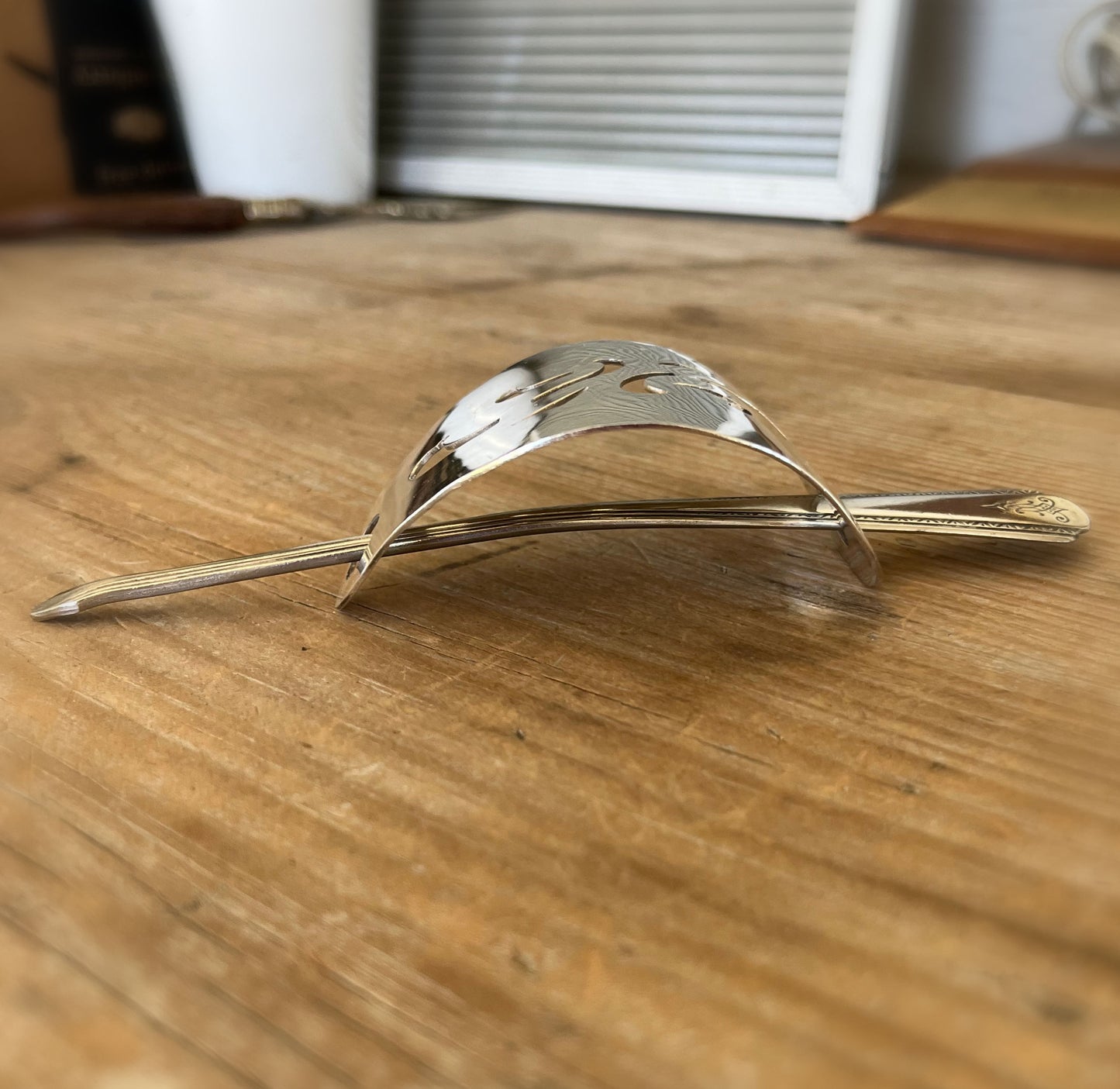 Side view of Senate Silverplate Jean cake server hair barrette worn in hair with stick - handcrafted from upcycled vintage silverware - Laughing Frog Studio