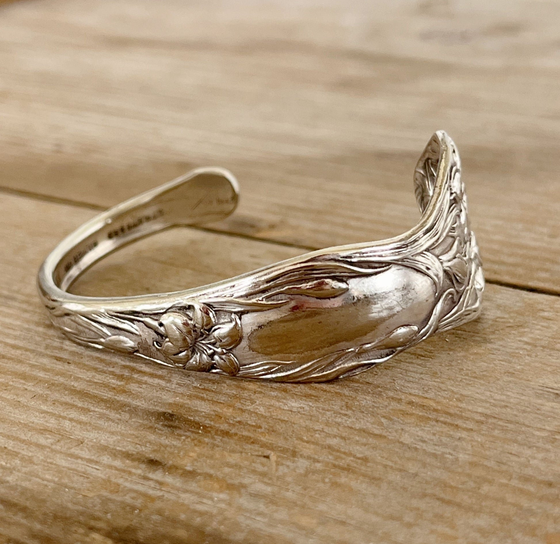 Close-up detail of Stratford Silverplate Lilyta pattern spoon cuff bracelet - upcycled vintage silverware - Laughing Frog Studio