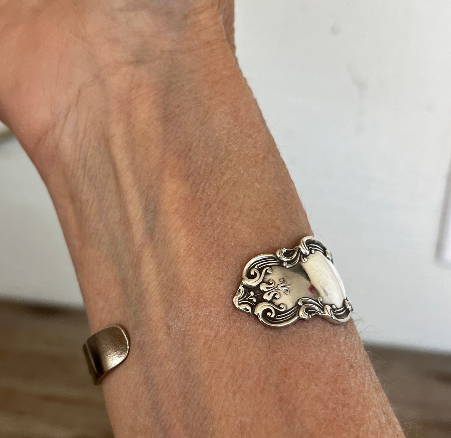 Tudor spoon cuff bracelet shown on model wrist - vintage silverplate with flowing Art Nouveau curves