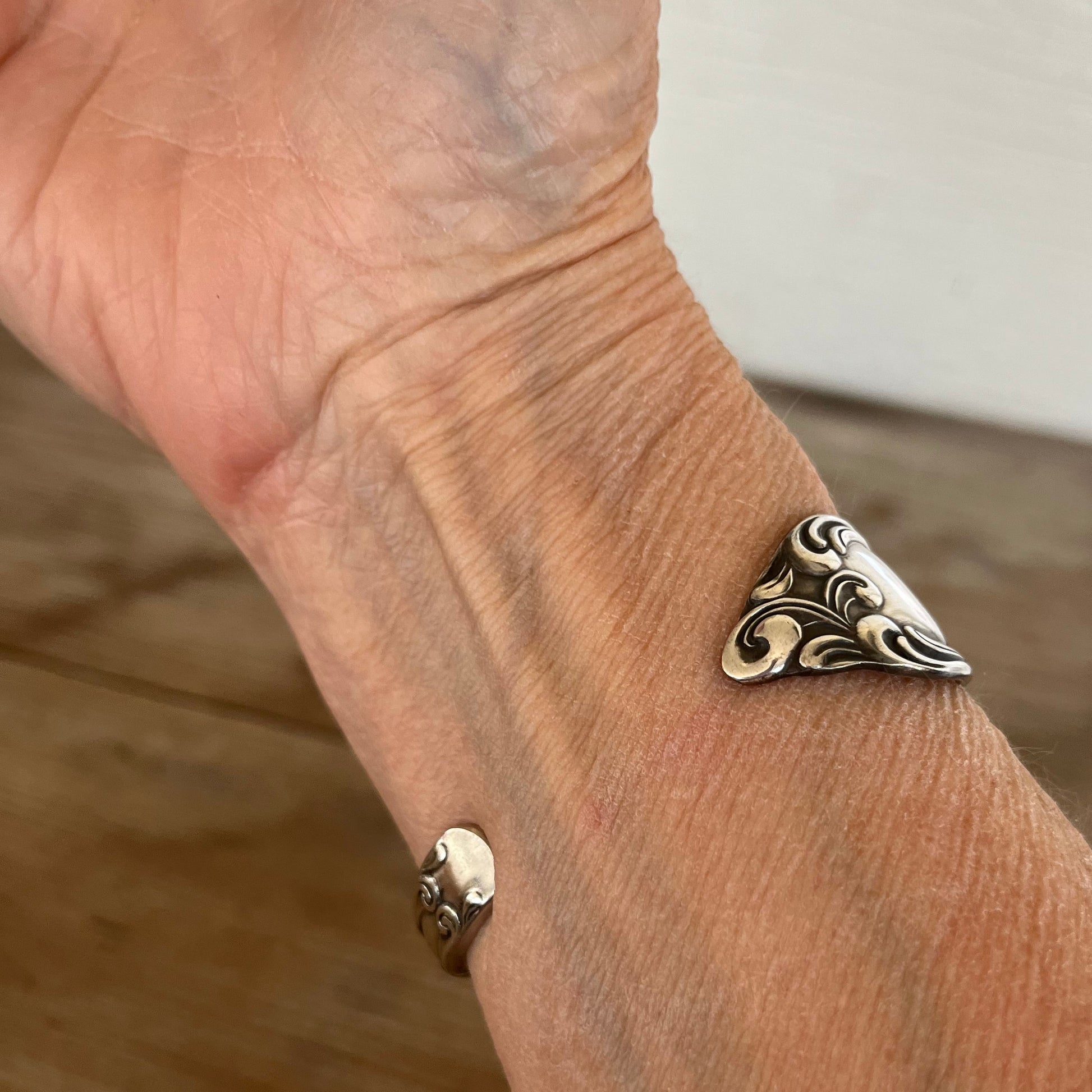 Old South spoon cuff bracelet on model wrist - upcycled 1949 Oneida silverplate vintage silverware - Laughing Frog Studio