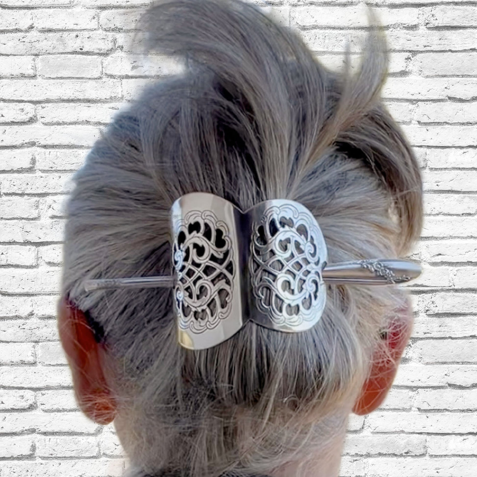 Handcrafted danish cake server barrette adorning bun hairstyle displaying Quess Bess silverware stick - upcycled vintage silverware - Laughing Frog Studio