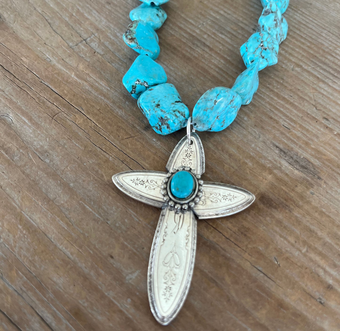 Closeup of Handcrafted spoon cross pendant on chunky turquoise howlite choker necklace - upcycled from vintage Argosy silverware - Laughing Frog Studio