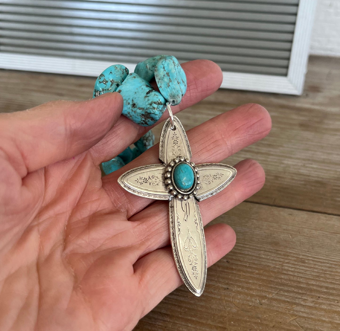 Handcrafted spoon cross pendant on chunky turquoise howlite choker necklace shown in hand for scale - upcycled from vintage Argosy silverware - Laughing Frog Studio