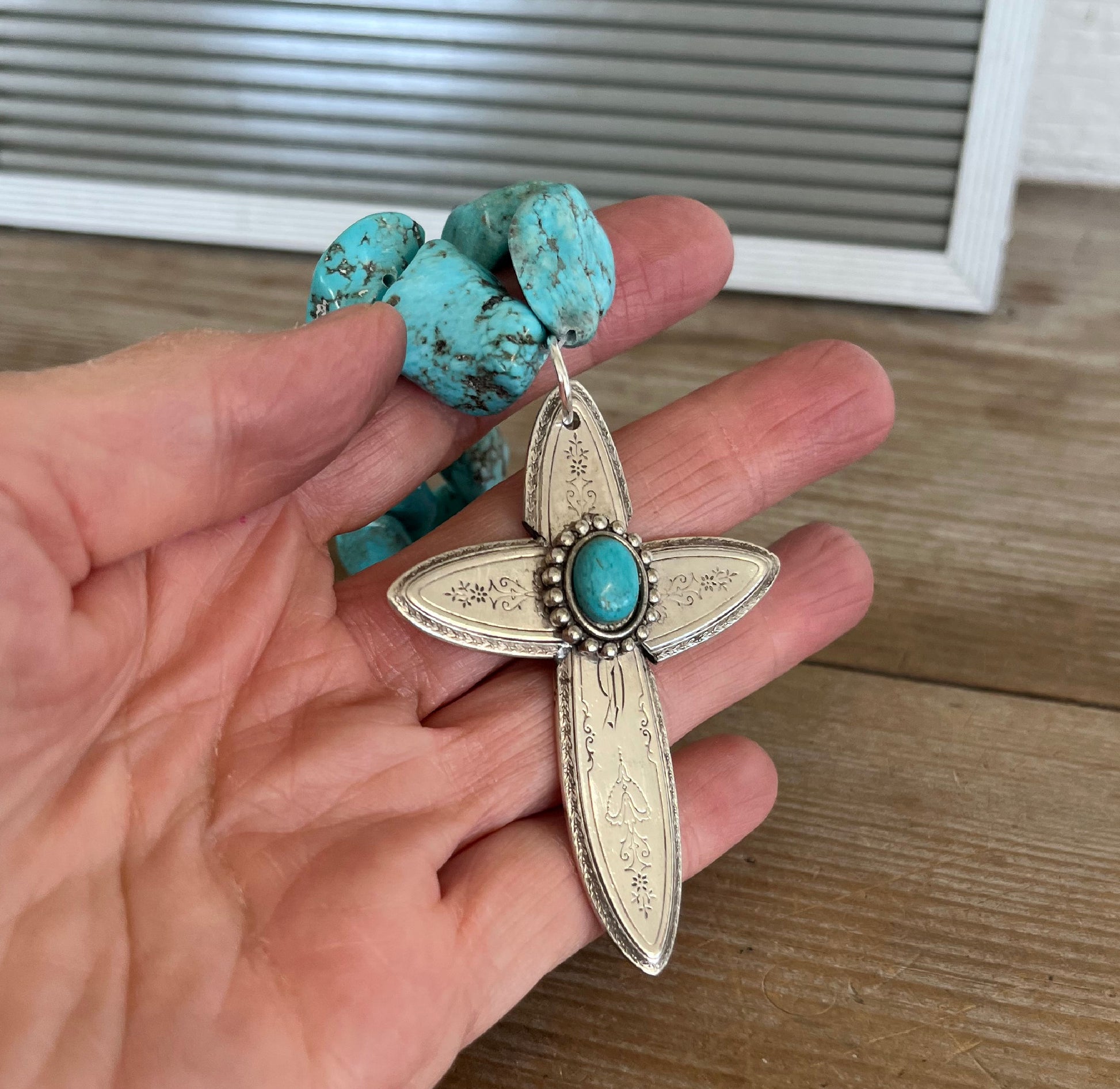 Handcrafted spoon cross pendant on chunky turquoise howlite choker necklace shown in hand for scale - upcycled from vintage Argosy silverware - Laughing Frog Studio