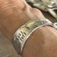 FUCKITY FUCK FUCK hand-stamped spoon cuff bracelet shown on a wrist - Stamped Spoon Bracelet - handcrafted from upcycled vintage silverware - Laughing Frog Studio
