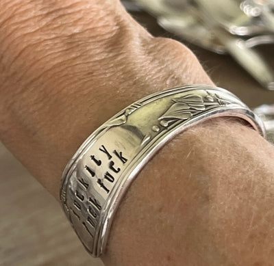 FUCKITY FUCK FUCK hand-stamped spoon cuff bracelet shown on a wrist - Stamped Spoon Bracelet - handcrafted from upcycled vintage silverware - Laughing Frog Studio