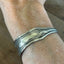 Vintage silverplate spoon cuff bracelet shown on wrist - handcrafted from upcycled vintage silverware - Laughing Frog Studio