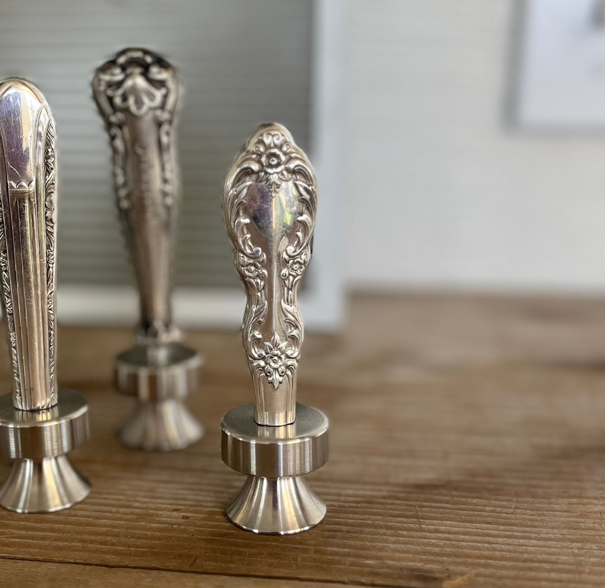 Close up of William Rogers Grand Elegance pattern knife bottle opener with ornate floral handle - handcrafted upcycled vintage silverware accessory - Laughing Frog Studio