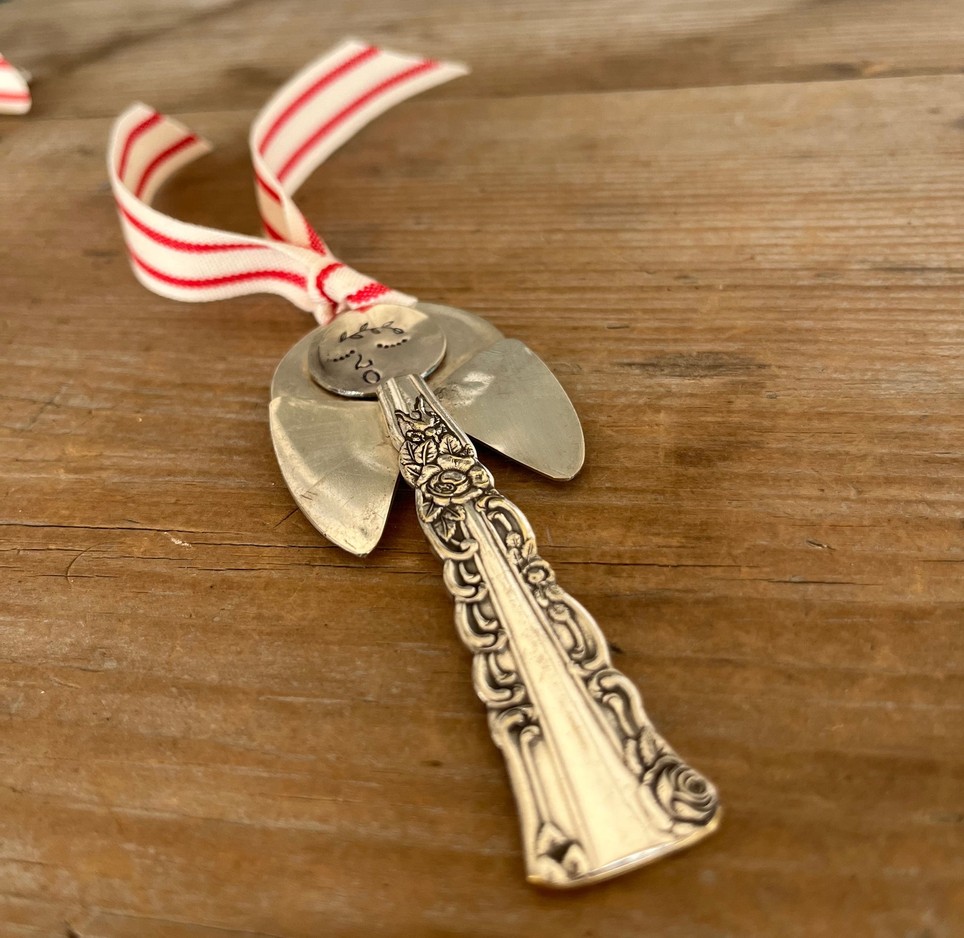 Detail view of Minerva artisan angel ornament with spoon handle body and spoon bowl wings  - handcrafted upcycled vintage silverware ornament - Laughing Frog Studio