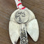 Cloe up of hand-stamped face of Minerva artisan angel ornament with spoon handle body and spoon bowl wings - handcrafted upcycled vintage silverware ornament - Laughing Frog Studio