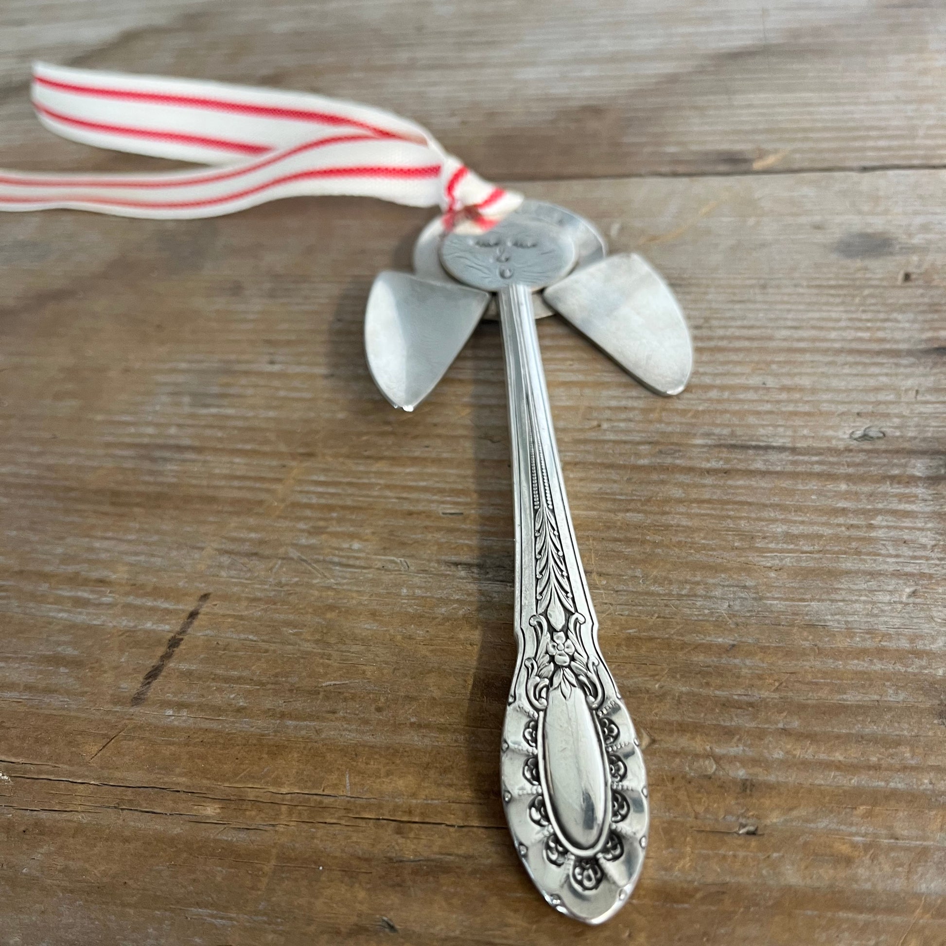 Wide angle of Josephine pattern artisan angel ornament with spoon handle body and spoon bowl wings with red striped ribbon hanger - handcrafted upcycled vintage silverware ornament - Laughing Frog Studio