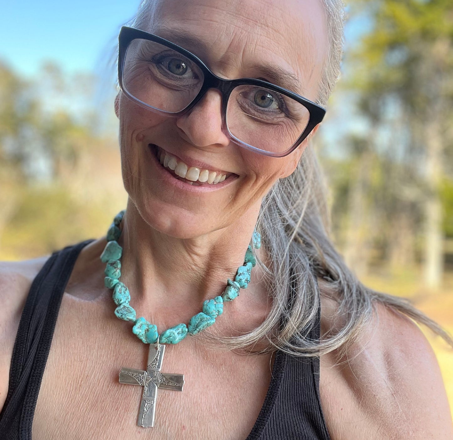 Jennifer Edmondson, owner, wearing Nobility Plate Caprice pattern spoon cross pendant on chunky turquoise howlite choker - handcrafted upcycled vintage silverware jewelry - Laughing Frog Studio