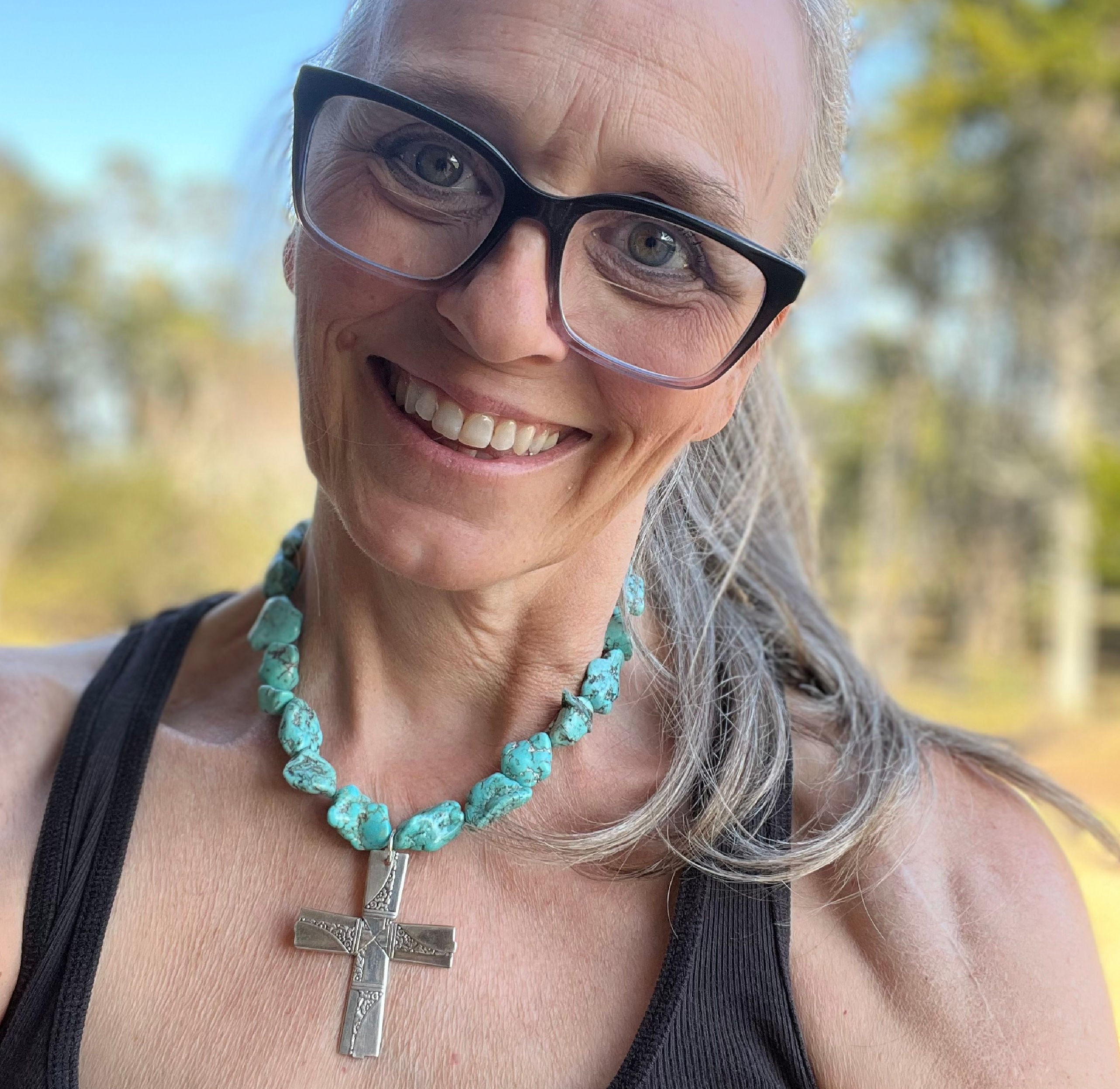 Jennifer Edmondson, owner, wearing Nobility Plate Caprice pattern spoon cross pendant on chunky turquoise howlite choker - handcrafted upcycled vintage silverware jewelry - Laughing Frog Studio