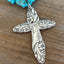 Close up of handmade spoon cross pendant on chunky turquoise howlite choker necklace - Evening Star 