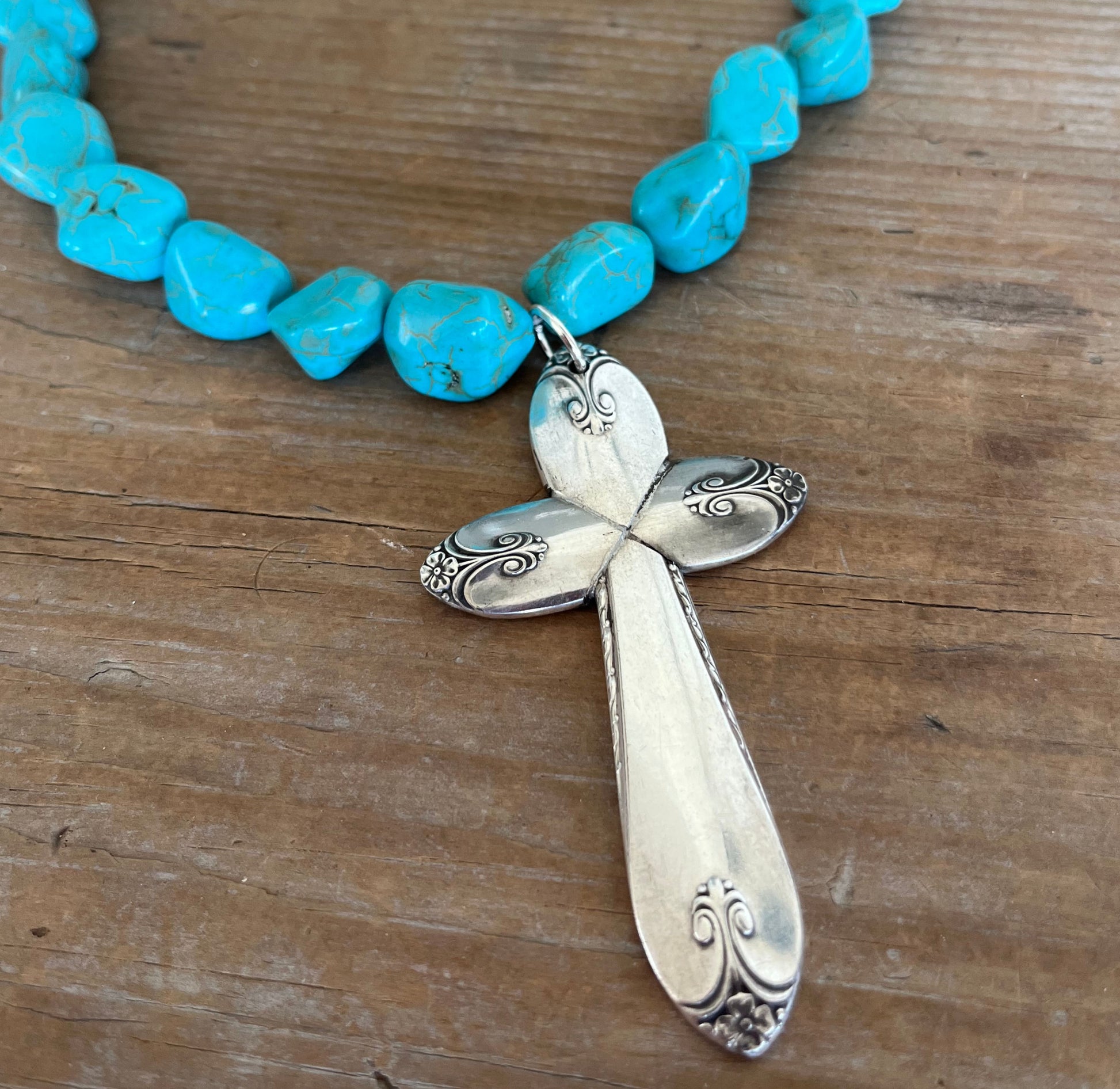 Close-up of cross pendant made from four vintage Exquisite spoon handles - upcycled silverplate Southwestern statement piece