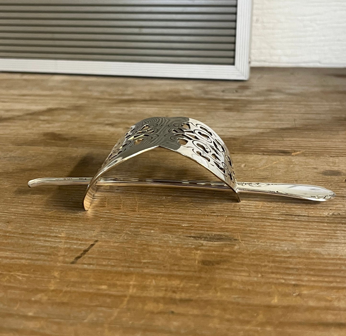 Side view of Danish cake server hair barrette with filigree floral cutout and meadow flower stick pin - handcrafted upcycled vintage silverware hair accessory - Laughing Frog Studio