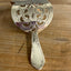 Close up detail of Danish cake server hair barrette with filigree floral cutout and meadow flower stick pin - handcrafted upcycled vintage silverware hair accessory - Laughing Frog Studio