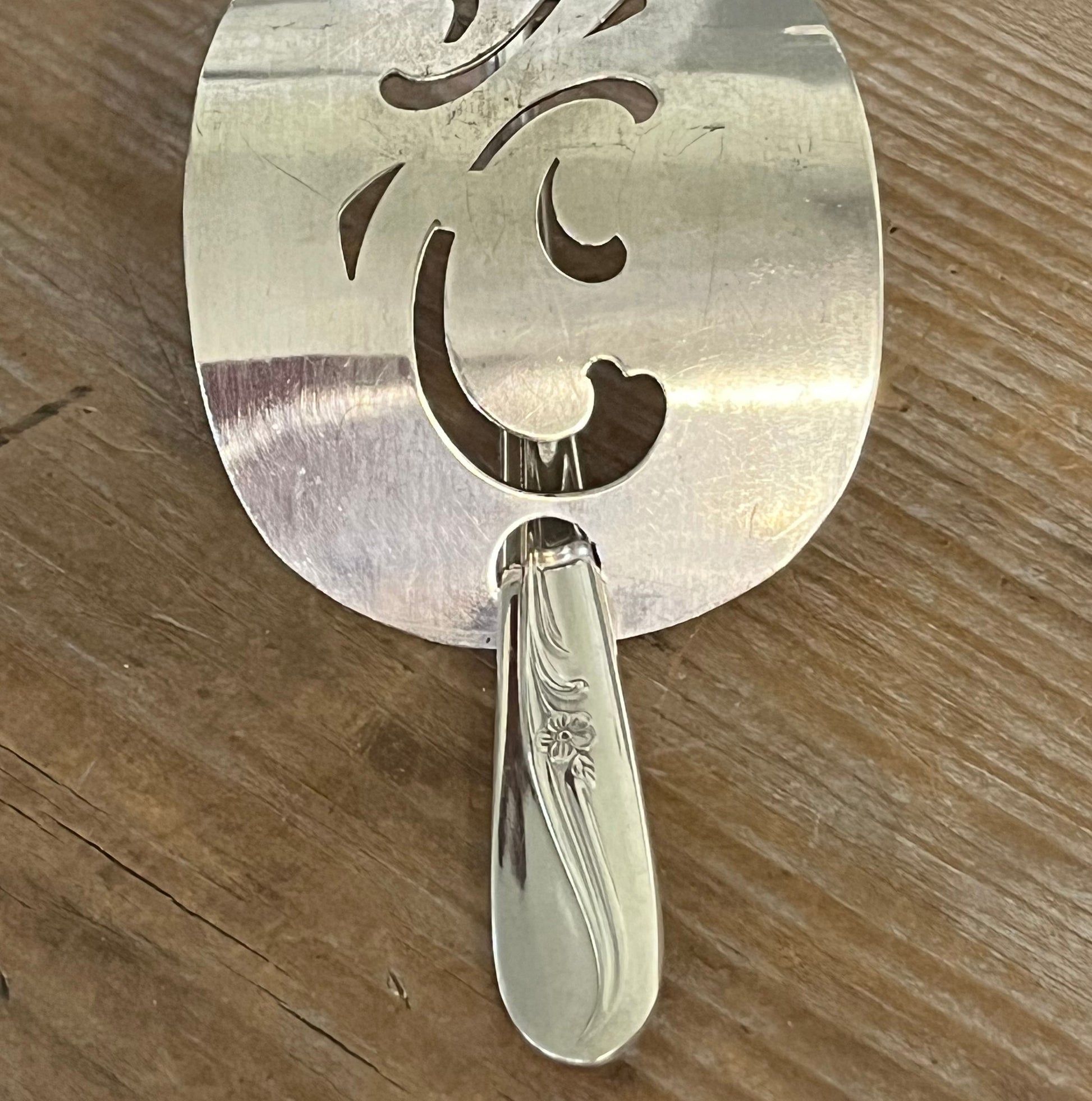 Detail view of Side view cake server hair barrette with cut-out scroll design with Oneida Meadowbrook stick - handcrafted upcycled vintage silverware hair accessory - Laughing Frog Studio