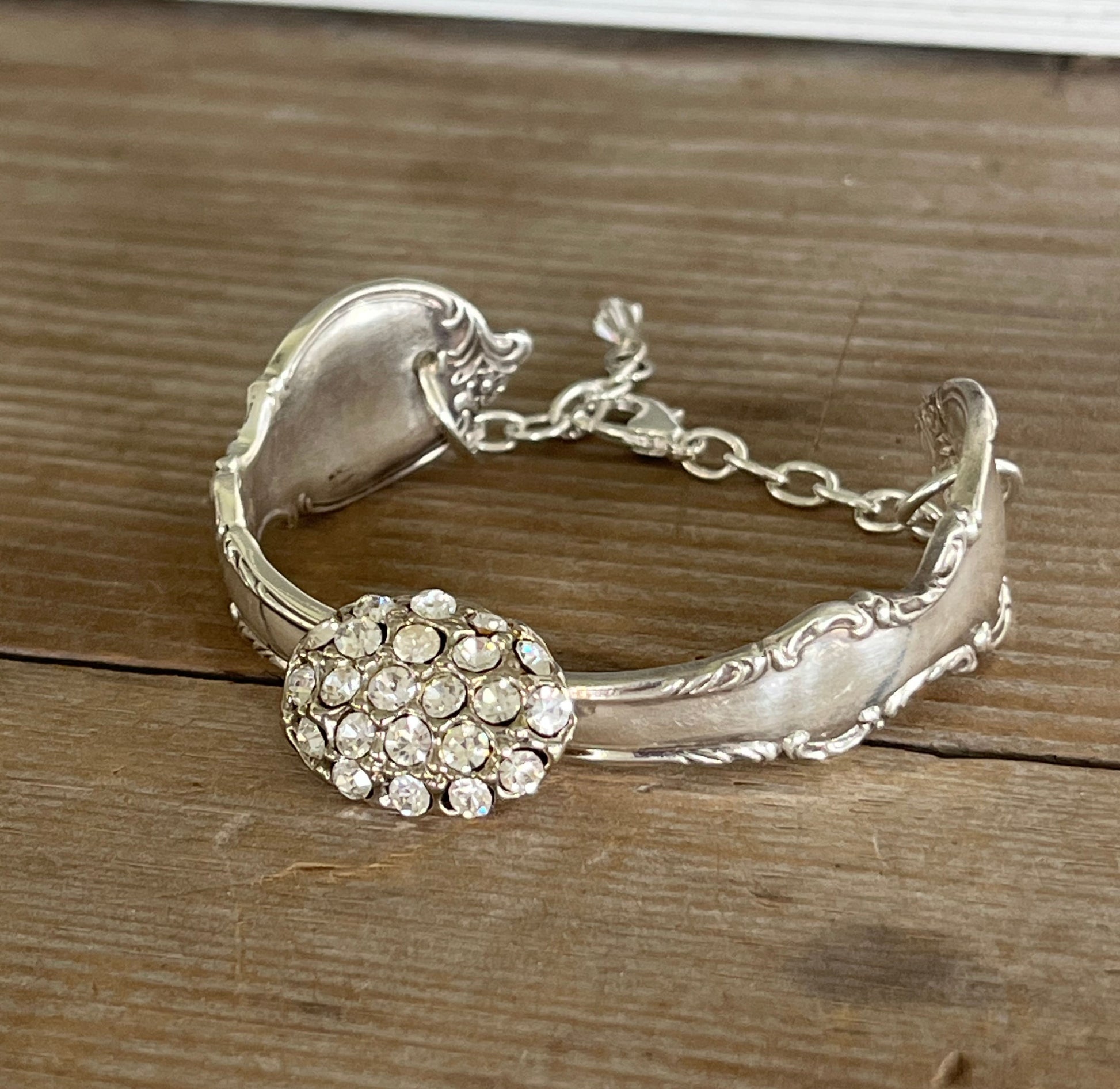 Front view of Reflection spoon link bracelet with rhinestone button center - handcrafted from upcycled vintage silverware - Laughing Frog Studio