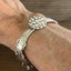 Closeup of silverware link of 1847 Rogers Brothers Reflection pattern spoon link bracelet on model - handcrafted from upcycled vintage silverware - Laughing Frog Studio