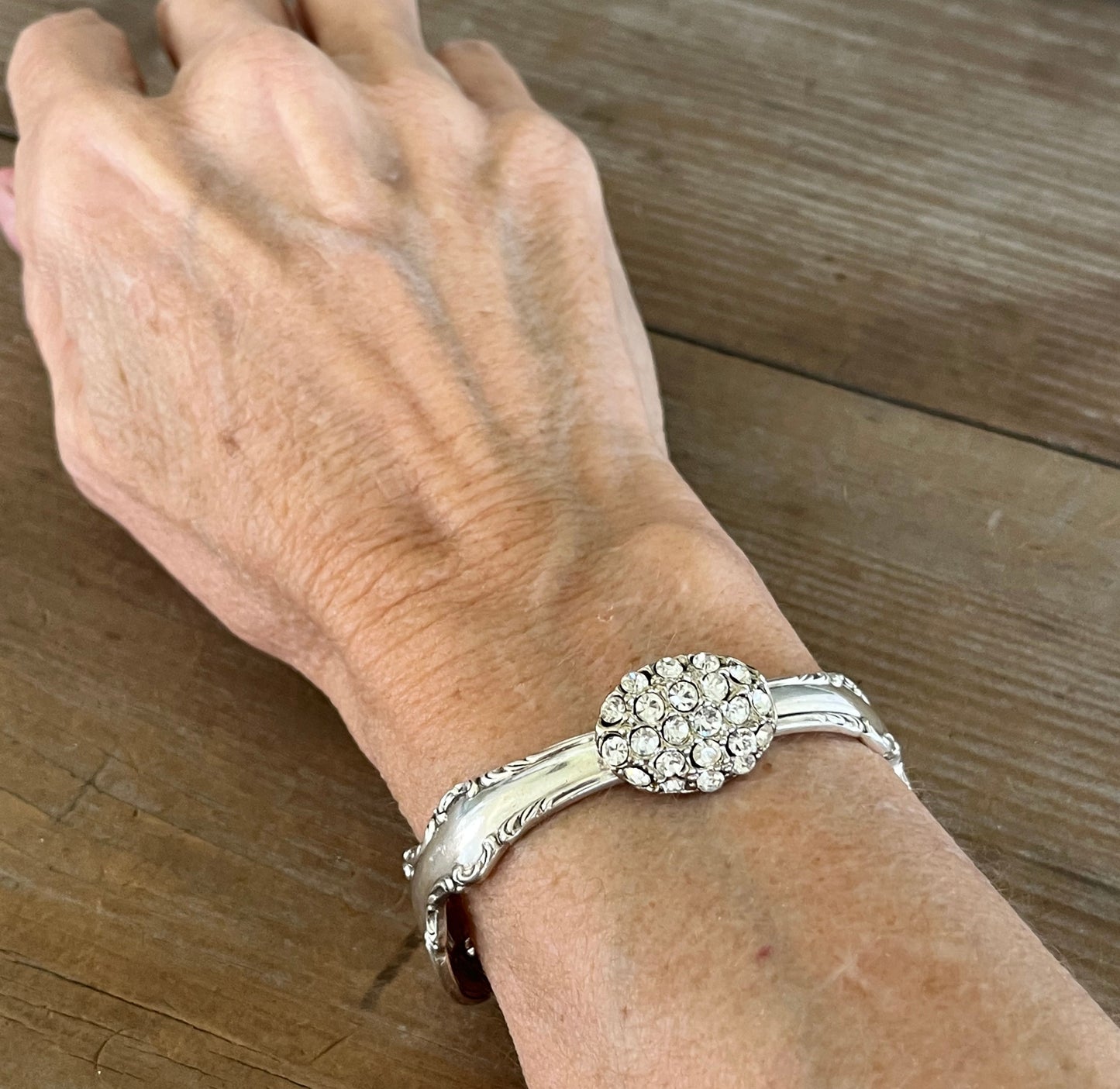 Silverware bracelet shown on a wrist for size - 1847 Rogers Brothers Reflection pattern spoon link bracelet - handcrafted from upcycled vintage silverware - Laughing Frog Studio
