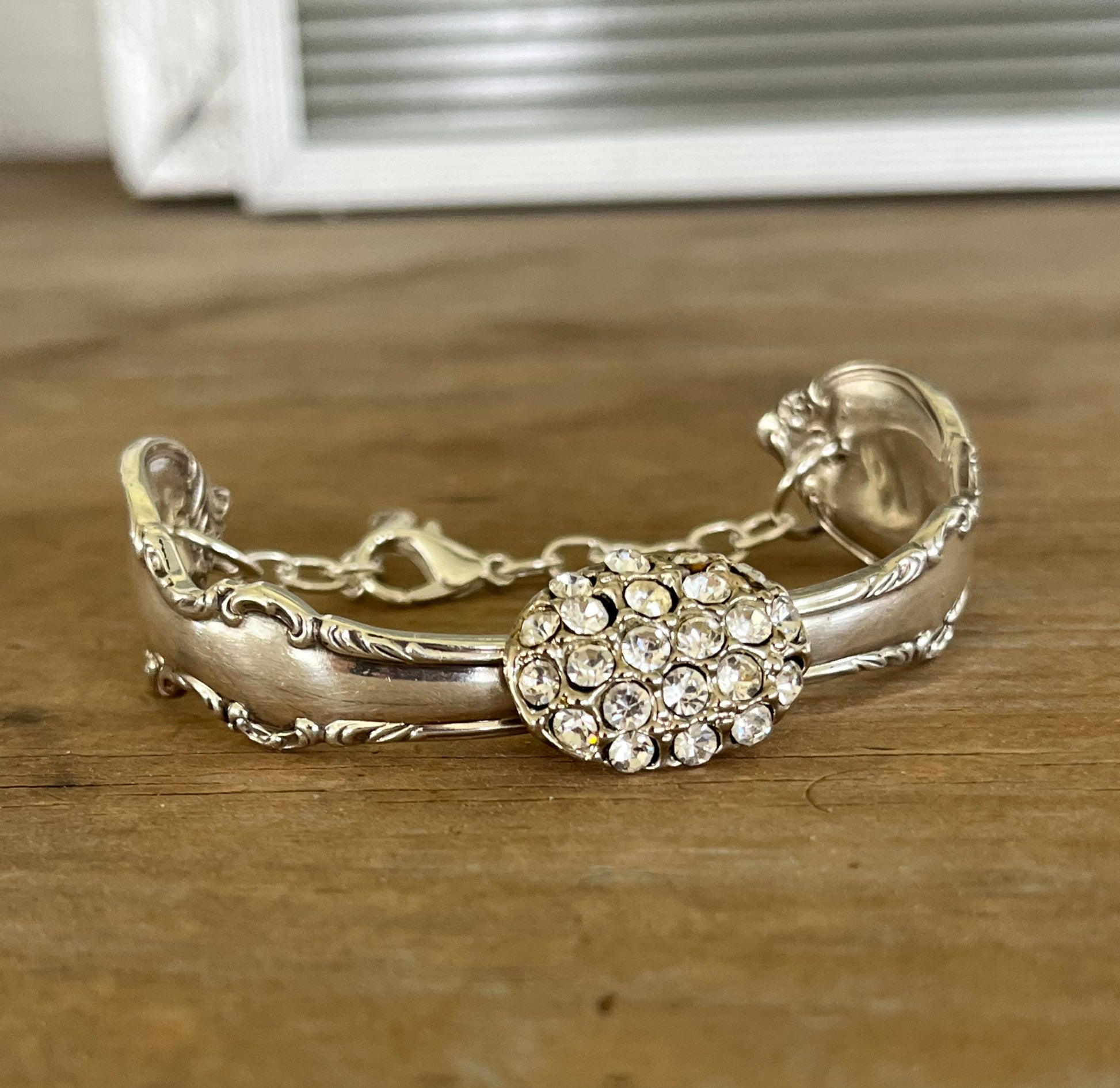 Close up view of vintage rhinestone button centerpiece on Reflection spoon link bracelet - handcrafted from upcycled vintage silverware - Laughing Frog Studio