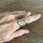 Tony the Tiger coil-wrap spoon ring showing on model - front face with mascot artwork - Spoon Ring - handcrafted from upcycled vintage silverware - Laughing Frog Studio