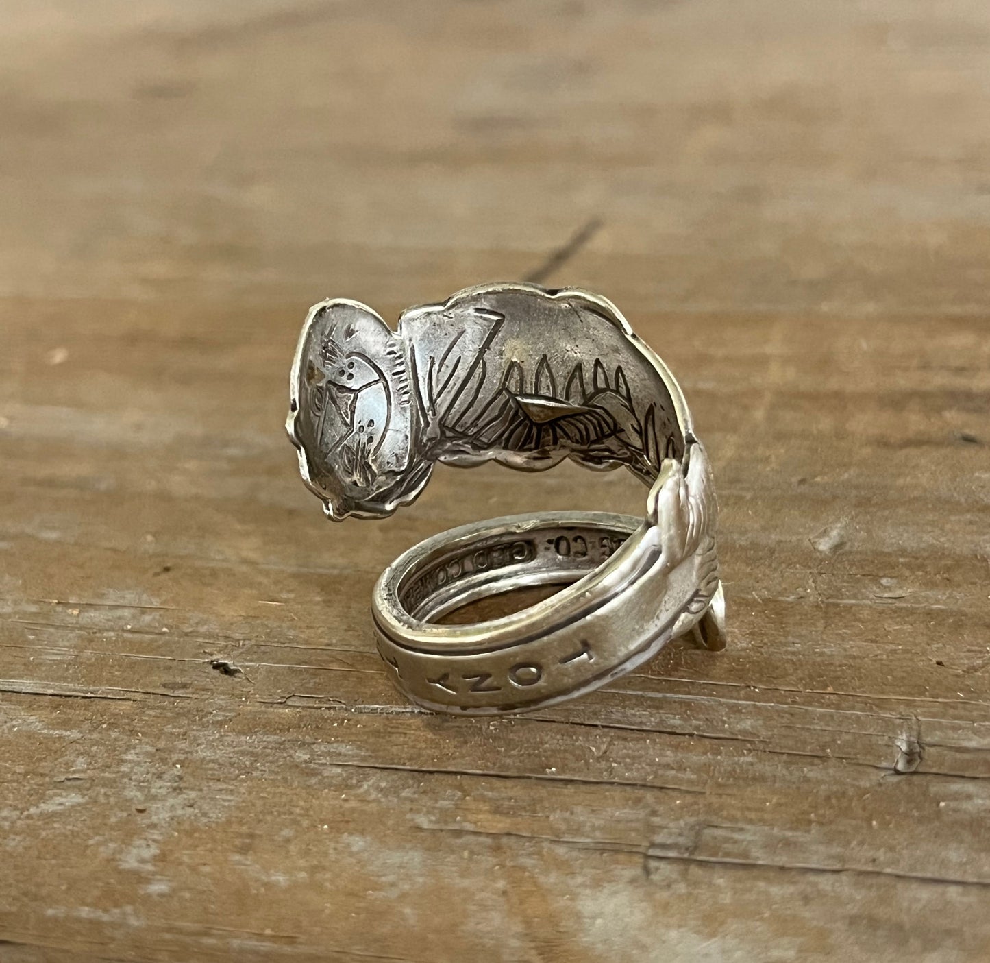 Angled view of Tony the Tiger coil-wrap ring showing vintage spoon artwork and patina - Spoon Ring - handcrafted from upcycled vintage silverware - Laughing Frog Studio