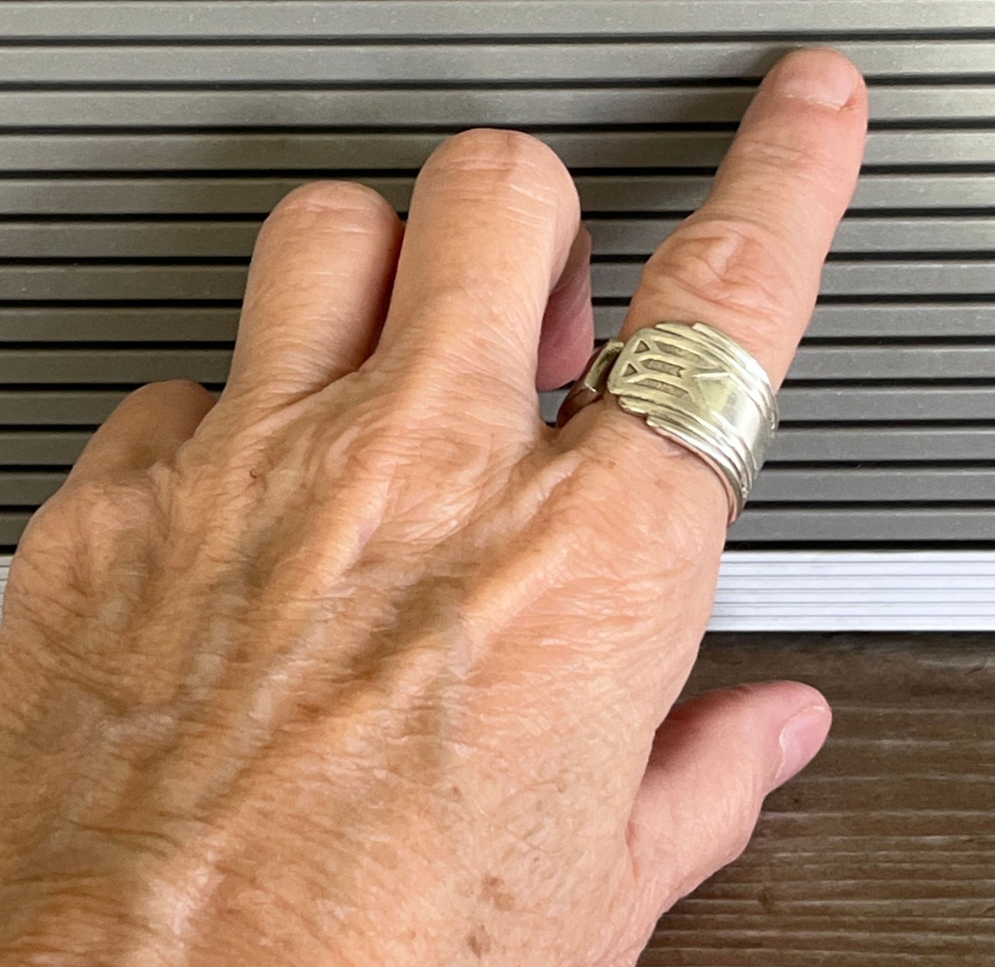 Art Deco geometric Oneida Friendship Medality spoon ring shown on hand - handcrafted from upcycled vintage silverware - Laughing Frog Studio