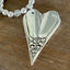 Close-up of sculptural floral heart silverware pendant on chunky choker - upcycled antique silverplate - Laughing Frog Studio