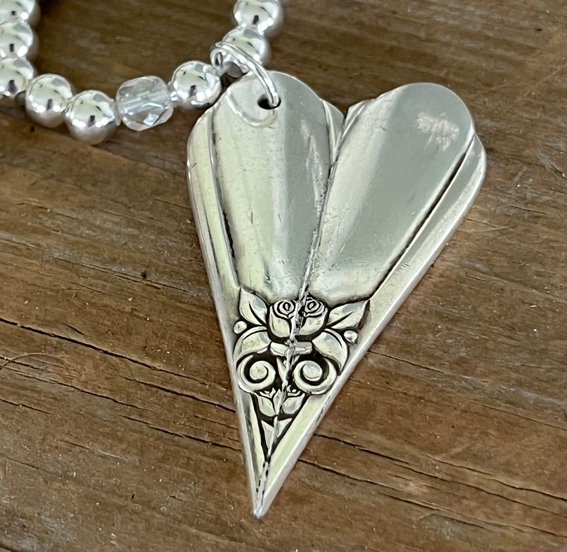 Close-up of sculptural floral heart silverware pendant on chunky choker - upcycled antique silverplate - Laughing Frog Studio